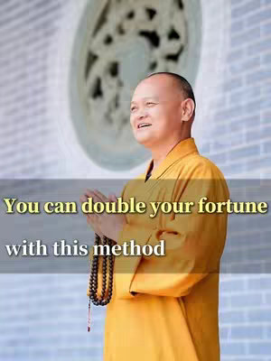 The image showcases a man, presumably a spiritual leader, in a yellow robe. He has his hands clasped in prayer, holding prayer beads. Above him, a large circular design is visible in the background. Text overlaid on the image reads, 'You can double your fortune with this method'.