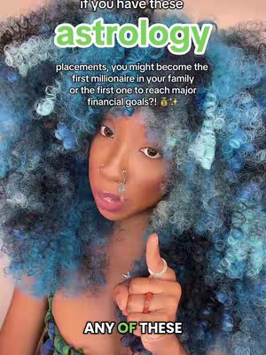 A person with blue curly hair and various face accessories points a thumbs up in front of a vibrant background. Text overlays list astrology information.