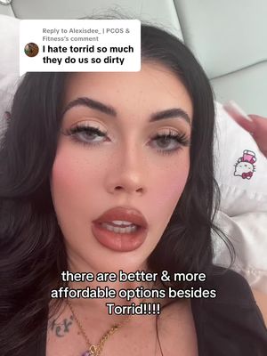 A selfie-style shot featuring a woman with dark hair and prominent makeup, looking directly at the camera. Text overlays are placed at the top and bottom of the frame, adding context. The overall aesthetic is polished, likely for a fashion or beauty-related video.