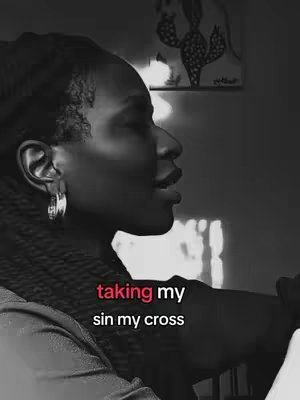 A black and white profile shot of a woman with dark skin, wearing hoop earrings, and a black head covering. The background includes vague shapes and objects, and text overlays at the bottom of the image. The woman's facial expression is that of speaking.