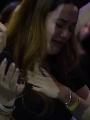 The cover image shows a close-up of a woman crying, with her face and upper body visible. Her eyes are closed, and tears are streaming down her face. She appears to be expressing deep emotion. The background is dark, suggesting a dimly lit setting or potentially a crowd. Another arm is extended, embracing her. The woman has long, wavy, light brown hair.