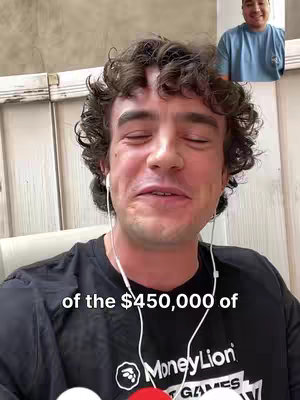 A selfie-style video call featuring a man with curly hair and a black t-shirt. He's wearing white earbuds and the bottom of his shirt displays a 'MoneyLion' logo. A second person is visible in a smaller, inset window in the top right.