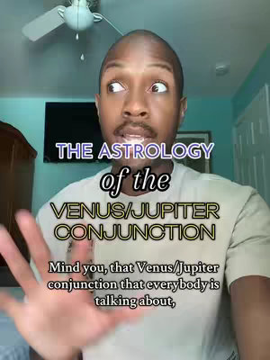 A man with short hair and a mustache is looking slightly off-camera toward the right. He is surrounded by text graphics, the main title of which says: THE ASTROLOGY of the VENUS/JUPITER CONJUNCTION. The background is a room with a blue wall, a television, closed curtains and a ceiling fan.