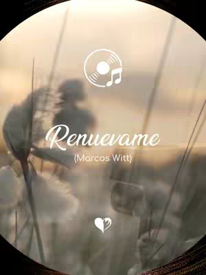 The image is a circular graphic with a blurred background of warm, sunset-like colors. Silhouettes of plants or tall grasses are visible in the foreground. Text in a stylish script reads "Renuévame" with the name "Marcos Witt" underneath in a smaller font. The logo for a music recording is placed near the top right, and a heart icon appears near the bottom center.