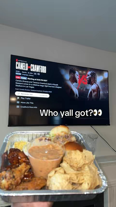 The cover image shows a television screen displaying a Netflix special titled "Canelo Crawford." The screen shows a boxing match with two fighters facing each other. In the foreground, a tray with a variety of foods is visible, including fried chicken, a container of sauce, and other items. The image is lit with a soft interior light.