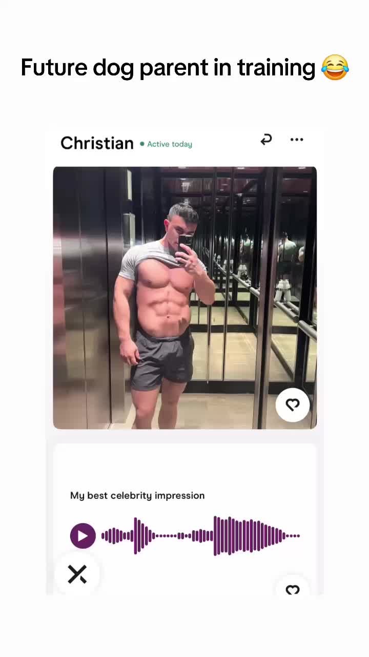 A selfie-style image featuring a man with a muscular physique, appearing to be in an elevator. He is shirtless and in shorts holding a phone up to take a selfie, with a dating app interface superimposed. There is a background with multiple mirrors reflecting the same scene.