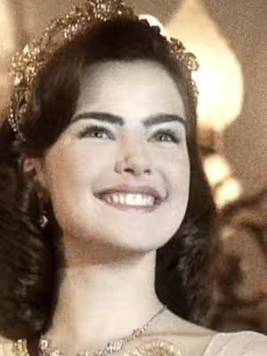 The cover image shows a woman smiling, facing slightly upward, wearing a gold crown and a necklace. The background is blurred.