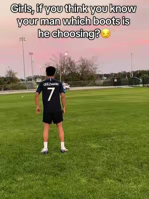 A person in a soccer jersey stands with their back to the camera on a grassy field. Text overlays the image, and the sky is a mix of pink and blue.