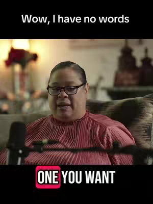 A woman wearing glasses and a pink shirt is sitting on a couch, talking into a microphone. The background is blurred, suggesting a home setting. The video has a banner with the words "ONE YOU WANT" on it. The image is styled in a way that could be from a podcast. The text overlay above the woman says, "Wow, I have no words."
