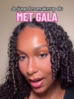 The cover shows a close-up of a woman with curly black hair. The text overlay reads "Je juge les makeup du MET GALA", set against a pink background. The woman is looking up and to the side, appearing to be speaking. 