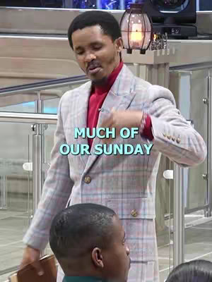 The cover image features a man in a plaid suit, standing in what appears to be a church or similar indoor setting. Text overlayed on the image reads "MUCH OF OUR SUNDAY" in turquoise letters. The man is speaking or gesturing, with an attentive audience partially visible in the foreground, showing their heads. The lighting is bright and professional, with a lantern visible in the background. Overall the image suggests a religious or inspirational message.
