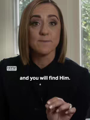 A medium shot of a woman with blonde hair, looking directly at the viewer. She is wearing a black top. Text overlayed on the bottom of image in white text.