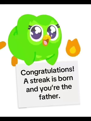 The cover image features the Duolingo owl character against a white background. The owl is green with large, expressive eyes, and a small piece of paper that reads “Congratulations! A streak is born and you’re the father.