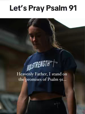 A woman in a navy crop top with white text looks downward with a solemn expression. Text overlays on the image convey a religious message.