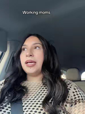 A woman with dark hair is centered in the frame, positioned inside what appears to be a car, with a seat visible in the background. She is looking slightly upwards and to her left with a neutral expression. She is wearing a beige, open-knit sweater. Above her head, the text 'Working moms' is displayed in a white, sans-serif font.