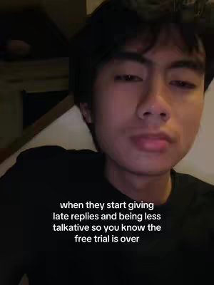 A young man with dark hair and a black shirt is looking towards the camera. The background looks dim and blurry, with hints of what looks like a room. White text is printed at the bottom.