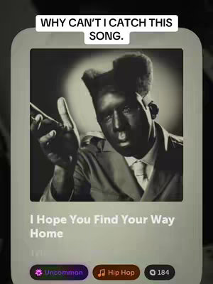 The image presents a black and white photograph of a person, with the head and chest visible, set against a soft backdrop. The person, who appears to be a man, is dressed in a suit and tie and is holding a microphone. Overlayed on the image is a display detailing a song title, artist, and associated context, including a section that reads "Uncommon", "Hip Hop" and gives a number "184". The image is framed inside a light-colored box with rounded corners.