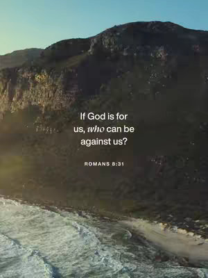 A scenic vista of a mountain range, with the ocean and a beach at the bottom, captured during the golden hour. The sky is a soft blue, blending into the mountainous background. Superimposed on this is a quote from Romans.