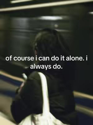 A person is seen from the back, slightly out of focus, standing in what appears to be a train or subway. The person is wearing a black jacket, and a white bag hangs over their shoulder. Text is overlaid on the image, in white, with a blurred background.