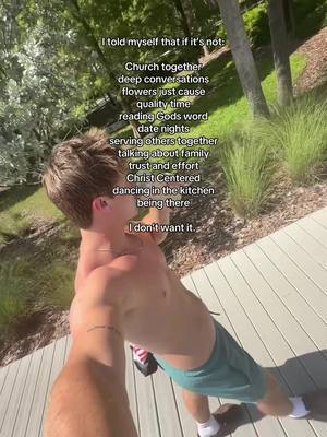 A man with short brown hair, wearing green shorts, and a white shirt is facing away from the camera, his back to the viewer and his right arm extended in front of him. The man has several lines of text overlayed on the image with the first line beginning “I told myself that if it’s not:”. The background is outdoors with trees and shrubbery, and daylight is present.