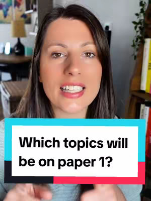 A woman with long brown hair is centered in the frame, looking directly at the camera and speaking. A teal and pink overlay with white text stating What topics will be on paper 1? is superimposed over her chest.