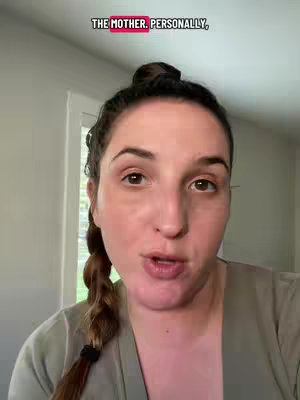 A close-up shot features a woman with brown eyes, fair skin, and a slight smile, wearing a green shirt. Her dark hair is styled in a braid that falls over her shoulder. A text overlay in a red box reads, 'THE MOTHER. PERSONALLY.' The background is a neutral-toned interior.