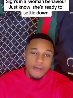 A man in a red shirt is lying on a patterned bedspread, looking toward the camera with a slight smirk. Text in a white box overlays the top, which appears to be the hook of the video.