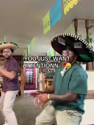 Two men in sombreros dance in a room decorated with colorful flags. Text is overlaid on the image.