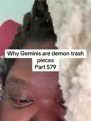 The cover image is a close-up selfie of a person, primarily focusing on their face and upper head. The person has dark hair with a textured appearance and appears to be looking down. The background is a soft, light color, possibly a wall or a surface. A text overlay appears at the center of the image, written in a white sans-serif font, against a black rectangular background. The text reads:

'Why Geminis are demon trash pieces

Part 579'