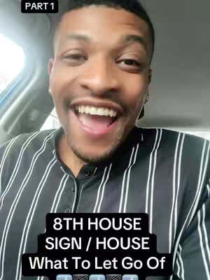 A selfie-style shot featuring a Black man inside of a vehicle. He is smiling widely with his mouth open, showing his teeth. He is wearing a black and white striped collared shirt. A text overlay at the bottom promotes content about astrology