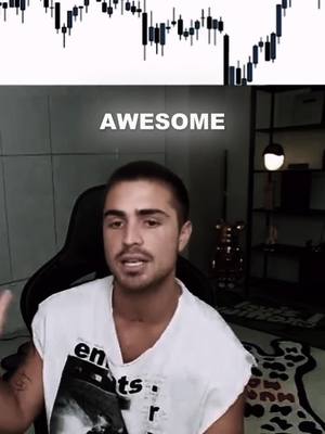 A man with short hair is seated indoors, with a chart visible behind him. Above him, in the top center, lies a chart composed of vertical lines. In front of the chart above his head, is the word 'AWESOME' in all capital letters.  The man is wearing a white shirt and is in front of a dark chair. The setting appears to be a room with a neutral background with a side table with a bear ornament on it. There is a white patterned carpet on the floor in the lower right of the image.