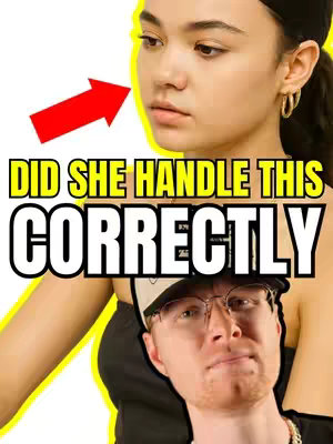 The cover image presents two faces juxtaposed. The primary focus is on a woman's face, slightly off-center and angled towards the viewer's left, with a red arrow pointing to her face. Beneath her, a man's face is visible. Bold, yellow-outlined text, reading “DID SHE HANDLE THIS CORRECTLY,” spans across the upper half of the image, overlaying both faces. The man is wearing glasses and a hat, and the composition uses a bright, attention-grabbing color scheme.