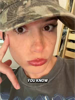 A close-up selfie of a person with a camouflage hat and a slightly pursed lips. The overlaid context is "YOU KNOW".