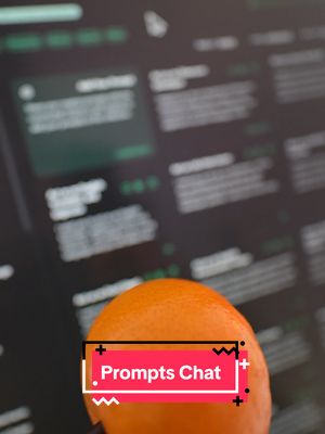The cover image is a close-up shot featuring an orange citrus fruit in focus in foreground. The blurred background of the image shows a computer screen displaying text, with a mouse cursor at the top. A red rectangular text overlay reads 'Prompts Chat'.