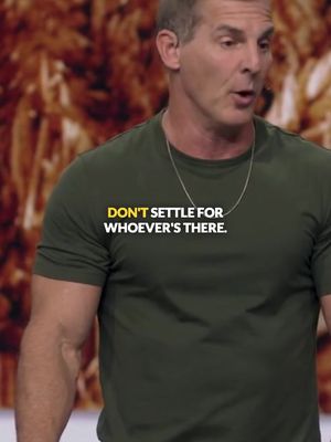 A man in a dark green t-shirt is speaking, against a blurry brown background. The text overlay "DON'T SETTLE FOR WHOEVER'S THERE" is displayed on his shirt.