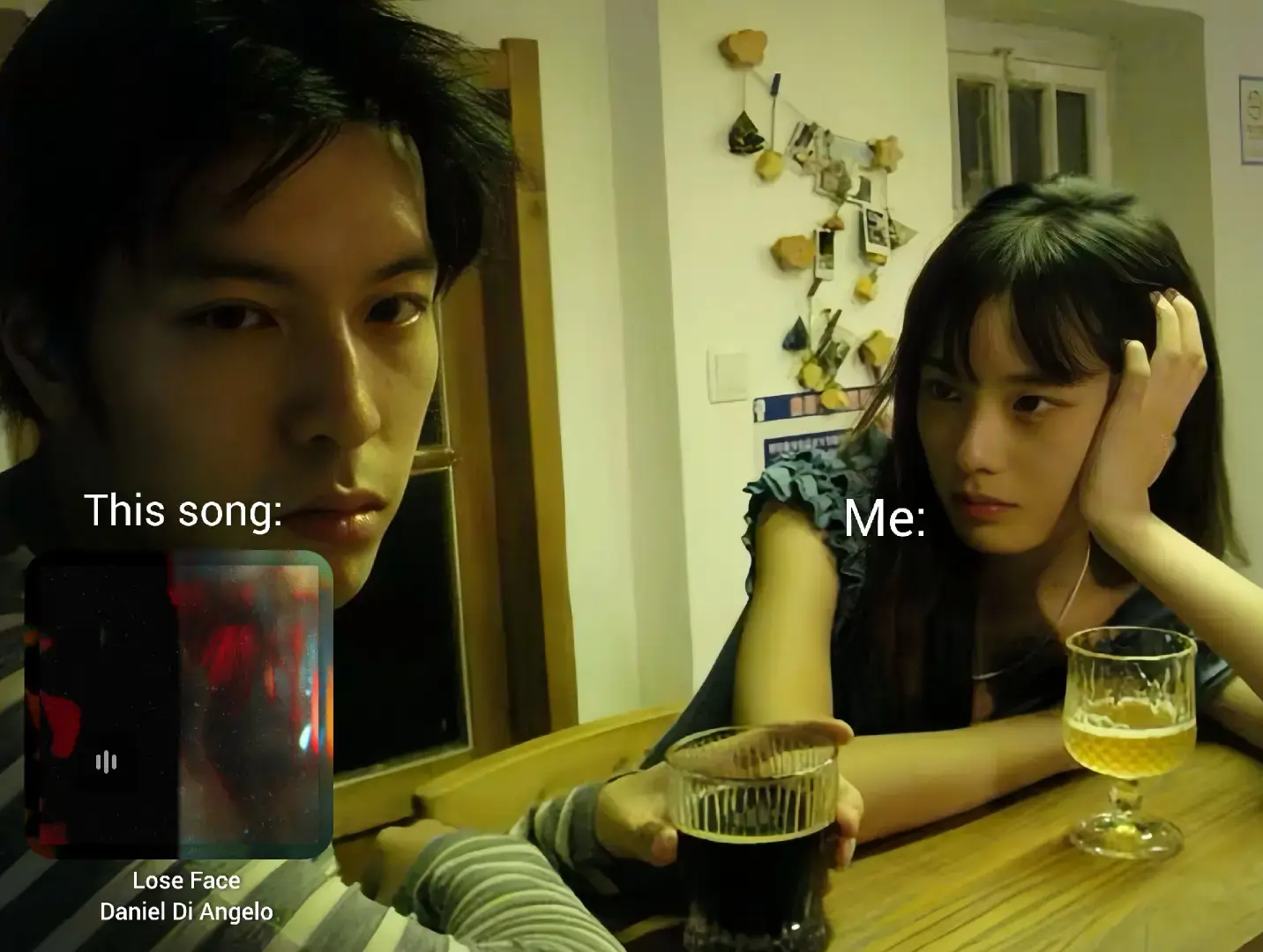 A split-screen image showing a man on the left, gazing intensely at the camera, and a woman on the right, looking off to the side with a thoughtful expression. The man has a dark, focused look, while the woman rests her hand on her cheek, appearing contemplative. A graphic overlay displays the song's details, positioned on the bottom left, with a play button. The background suggests an interior space.