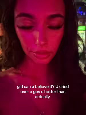 A close-up shot of a woman looking downcast, with her face illuminated by pinkish lighting. Text overlayed reads a message about heartbreak and an ex-partner.