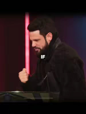 The cover image features a man in a black jacket, seen from the side and slightly angled. The man is looking down, with a somewhat somber expression on his face and clenched fist. Above him, a white text overlay reads "IF". The background is dark, primarily black and deep red, with a hint of lighting. The composition is vertically oriented, emphasizing the figure and the text.