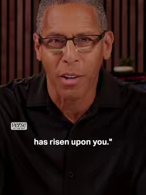 The cover image shows a close-up of a man with short, graying hair and glasses. He is wearing a black button-up shirt. The background is blurred, with vertical wooden paneling. Text overlay at the bottom reads, "has risen upon you."