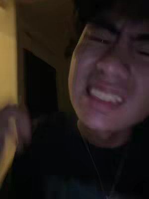 The cover image is a close-up shot of a person's face with a visible expression of intense emotion, like anger or frustration. The image is slightly out of focus and has a dim, yellowish lighting, suggesting the scene takes place indoors. The composition focuses solely on the face, emphasizing the person's emotional state.