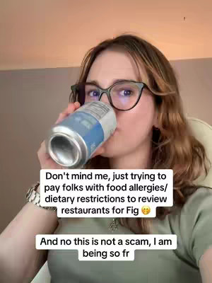 A woman with glasses is drinking from a can. Text overlays the image.