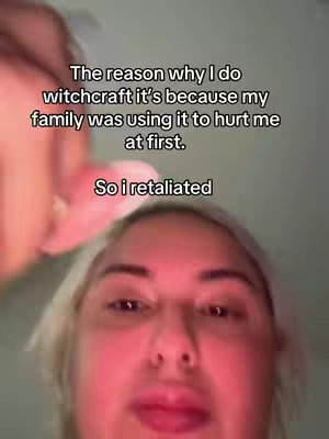 A selfie-style video cover image, the shot focuses on a woman's face. Positioned from a slightly upward angle, the subject, who appears to have light hair and is looking down at the camera. The lighting is dim. Text overlay is on the image.