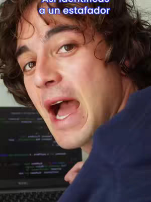 A close-up shot of a young man with dark hair, wearing a dark blue shirt, looking towards the camera with an open mouth and wide eyes. Text overlayed onto the top reads "Así identificas a un estafador."