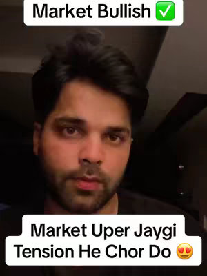A medium shot of a man facing the camera, likely indoors, with text overlays at the top and bottom. The background is dark, and the man appears to be speaking, with a slightly concerned or thoughtful expression. The top overlay reads "Market Bullish" with a green checkmark, while the bottom text says, "Market Uper Jaygi, Tension He Chor Do" with a pair of smiling eyes.