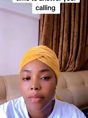 The cover image features a close-up of a woman's face, framed from the chest up. She is wearing a yellow turban/head covering. The background includes a light beige wall and a glimpse of brown curtains. The text overlay in a white rectangle reads "time to answer your calling". The woman has a neutral expression, looking slightly towards the bottom right.