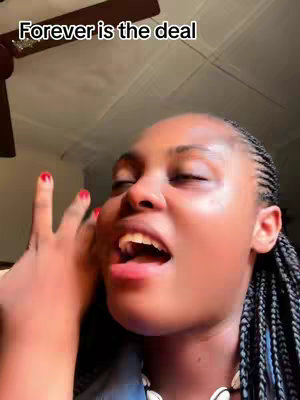 The cover image is a close-up shot of a black woman in the bottom-right of the frame, facing upwards and to the left. She has her mouth open, as if singing or speaking excitedly. Her hand is raised, with her fingers near her face. Her hair is braided. The background is slightly out of focus, showing a ceiling or wall.