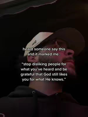 A man in a black hoodie and a white hat is seen from the chest up. He is in a dark setting. Text overlays are present, conveying a message related to judging people.