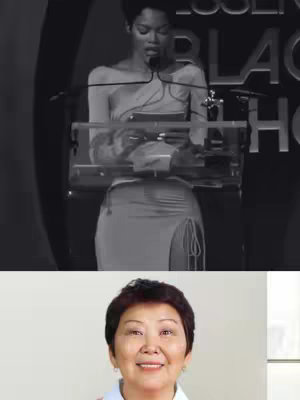 The cover image is a black and white photo featuring a woman at a podium speaking into a microphone. She is dressed in a dress and the image is clear.