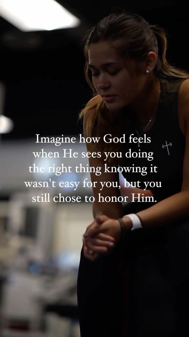 A young woman with dark hair pulled back in a ponytail is shown from the mid-chest up, seated and looking down pensively. She wears a dark tank top. Text overlays frame the image with inspirational words.