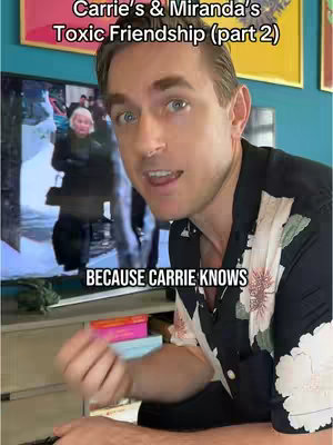 A man with light skin is positioned in front of a TV screen showing a scene from Sex and the City. He is looking directly at the camera and talking. The text overlays are in white. The background includes a teal wall, gold-framed artwork, and a light-colored TV stand. The man is wearing a black shirt with a floral pattern.